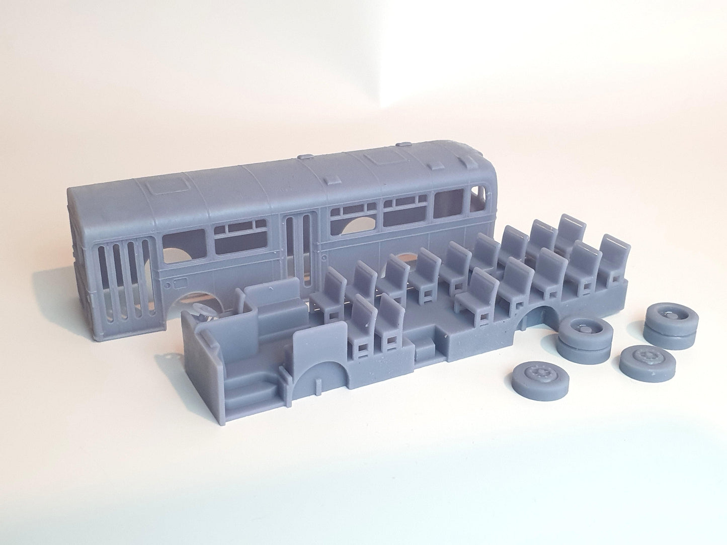 Shows the separate shell, inside and wheels that make up the OO scale model bus f the Coventry Bristol RE - Three Peaks Models