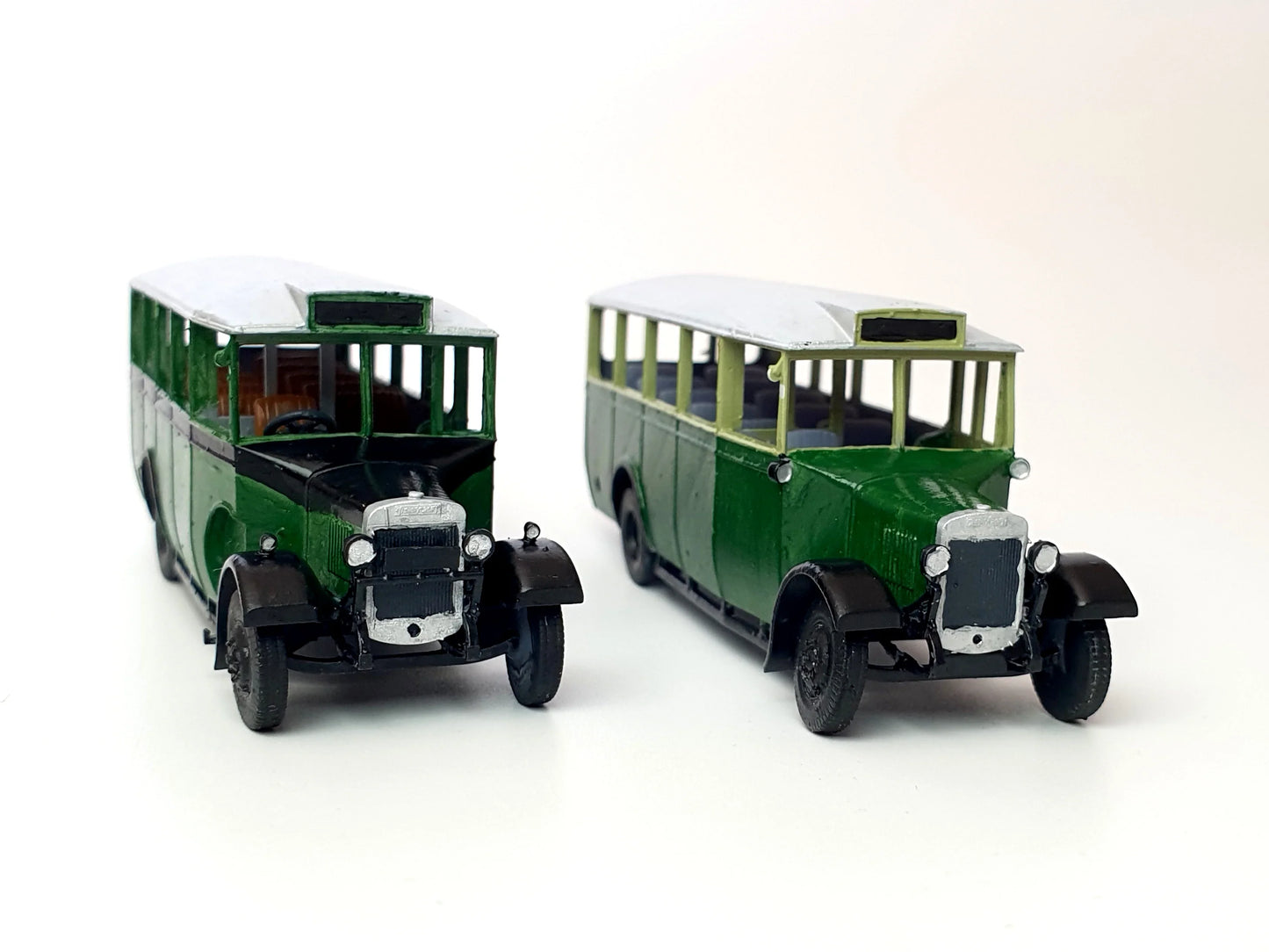 Front view of painted examples of the General and London transport versions of our scale model 20-seat Thornycroft bus - Three Peaks Models