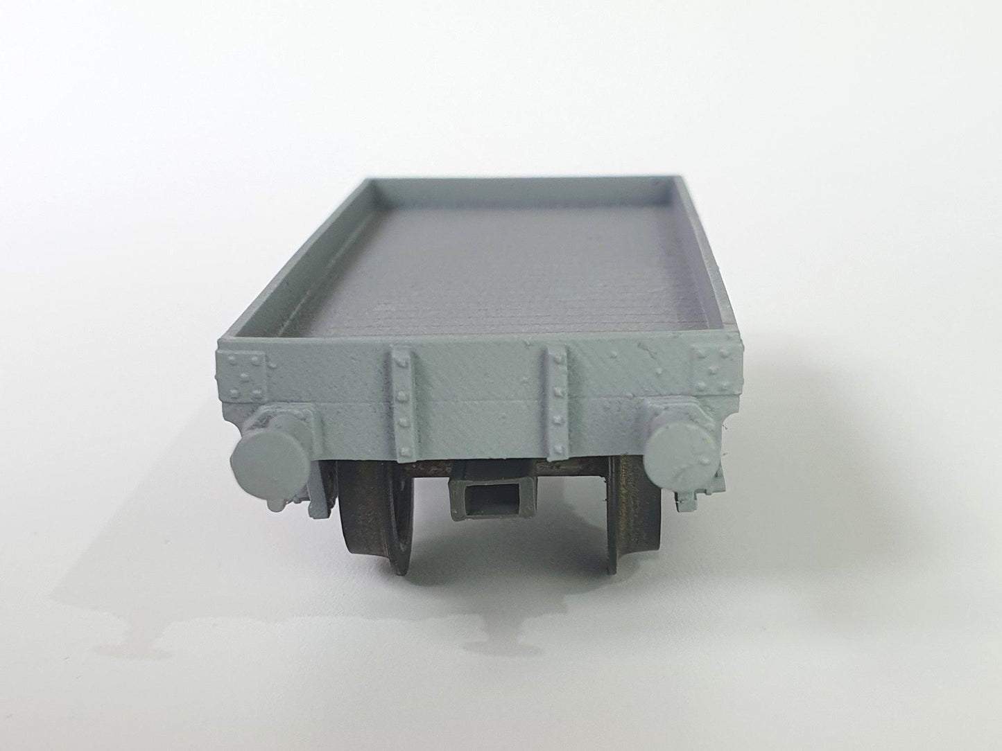 OO (1:76) scale model of an L&Y Diagram 1 Low Goods wagon viewed from the end, showing a standard NEM pocket for attaching couplers - Three Peaks Models