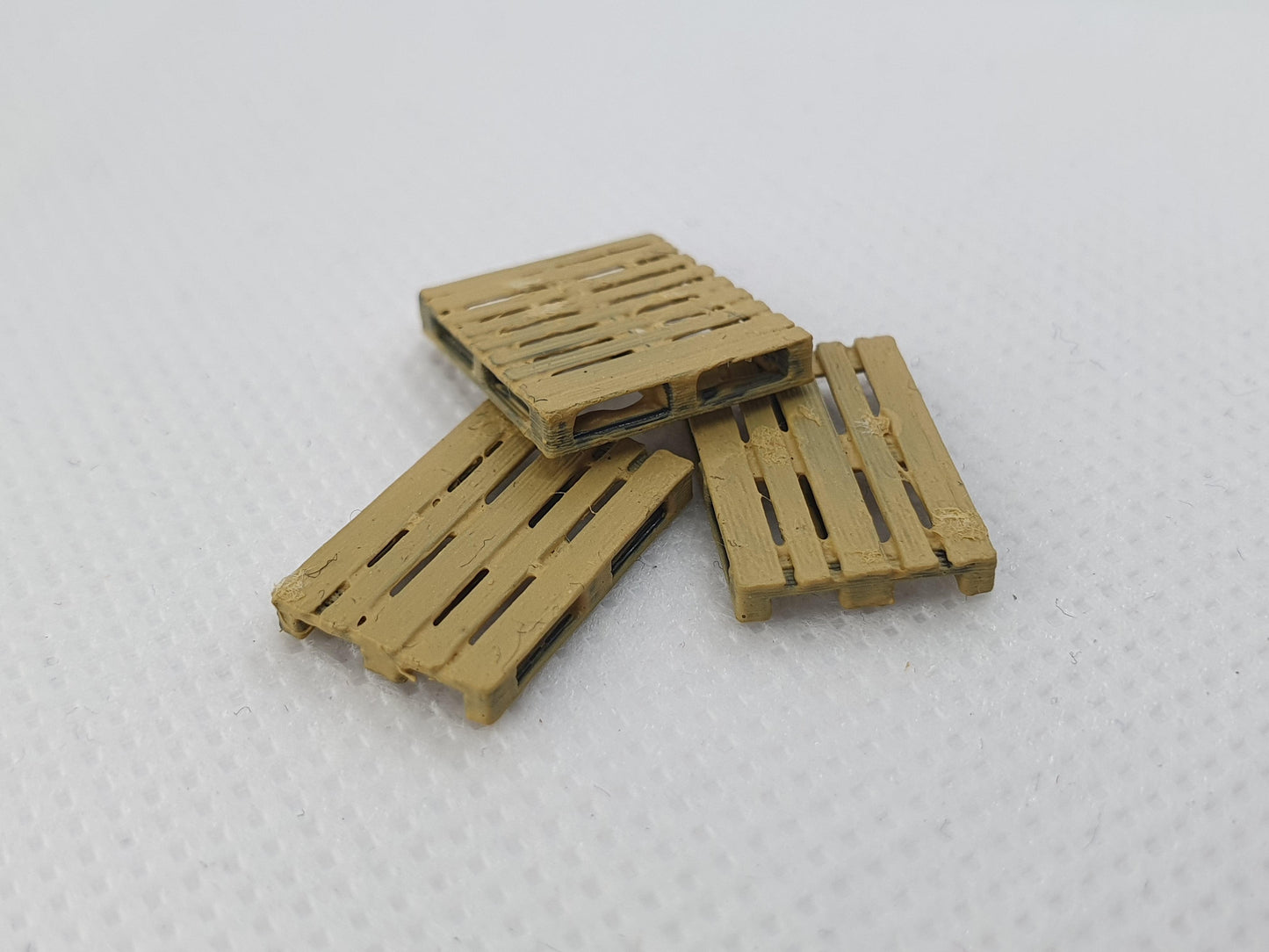 Stack of painted OO gauge scale model pallets - Three Peaks Models
