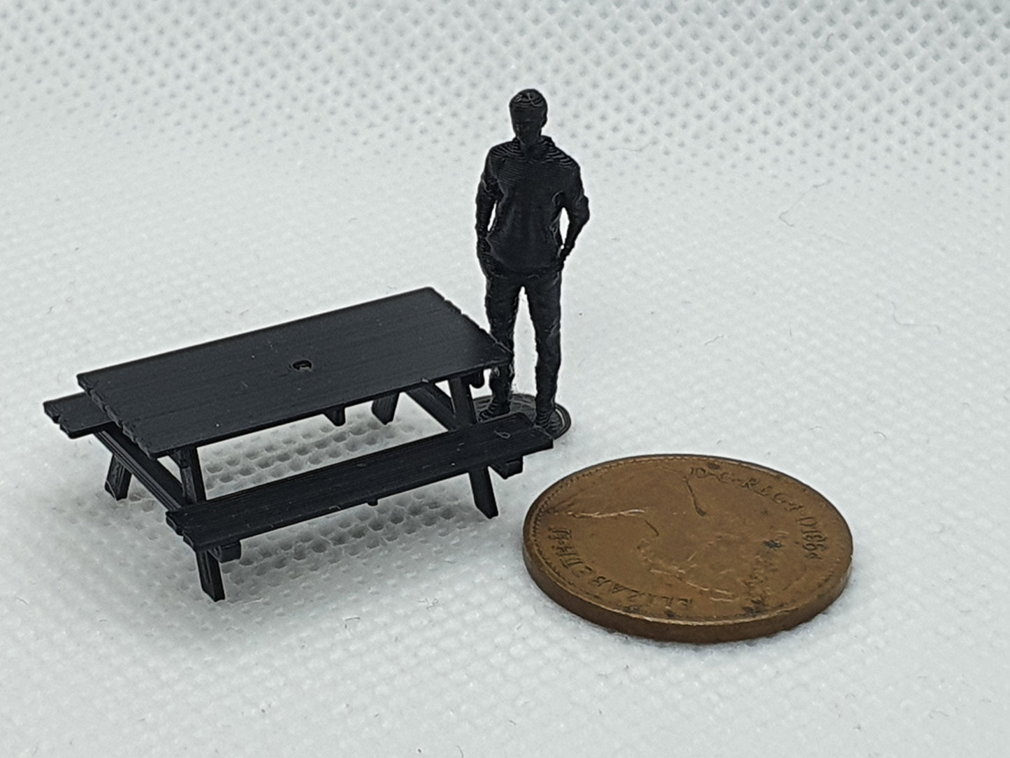 OO gauge scale model picnic bench with OO figure and a penny for scale - Three Peaks Models