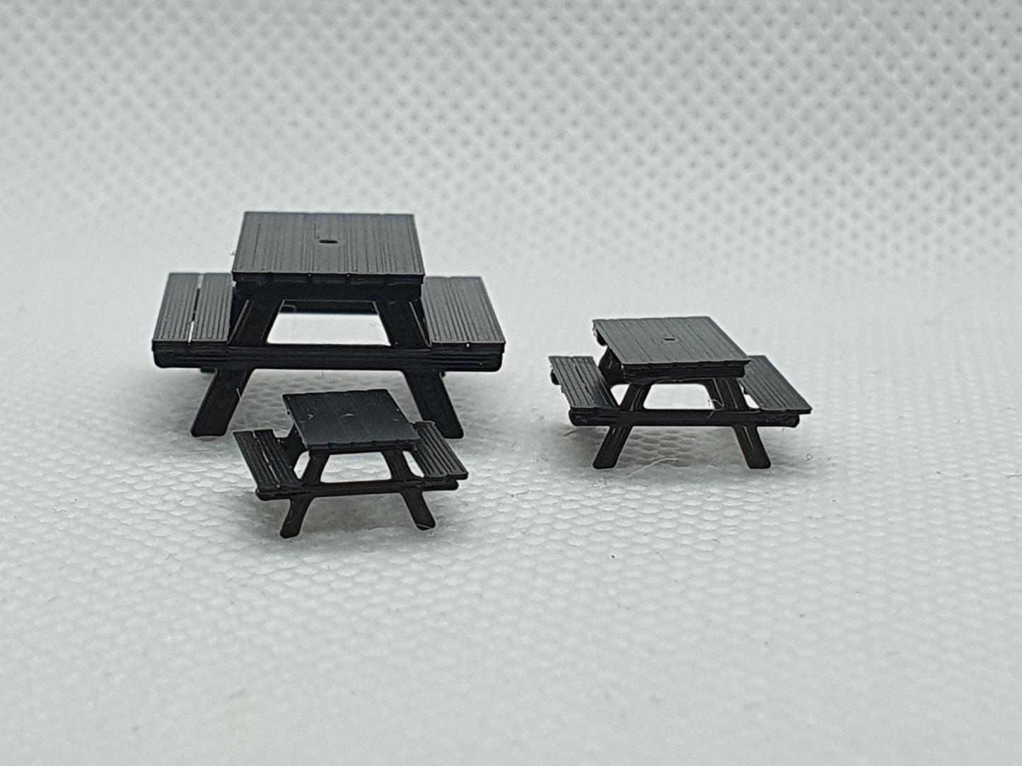 End view of 3 scale model picnic benches, one in OO, one in TT and one in N gauge - Three Peaks Models