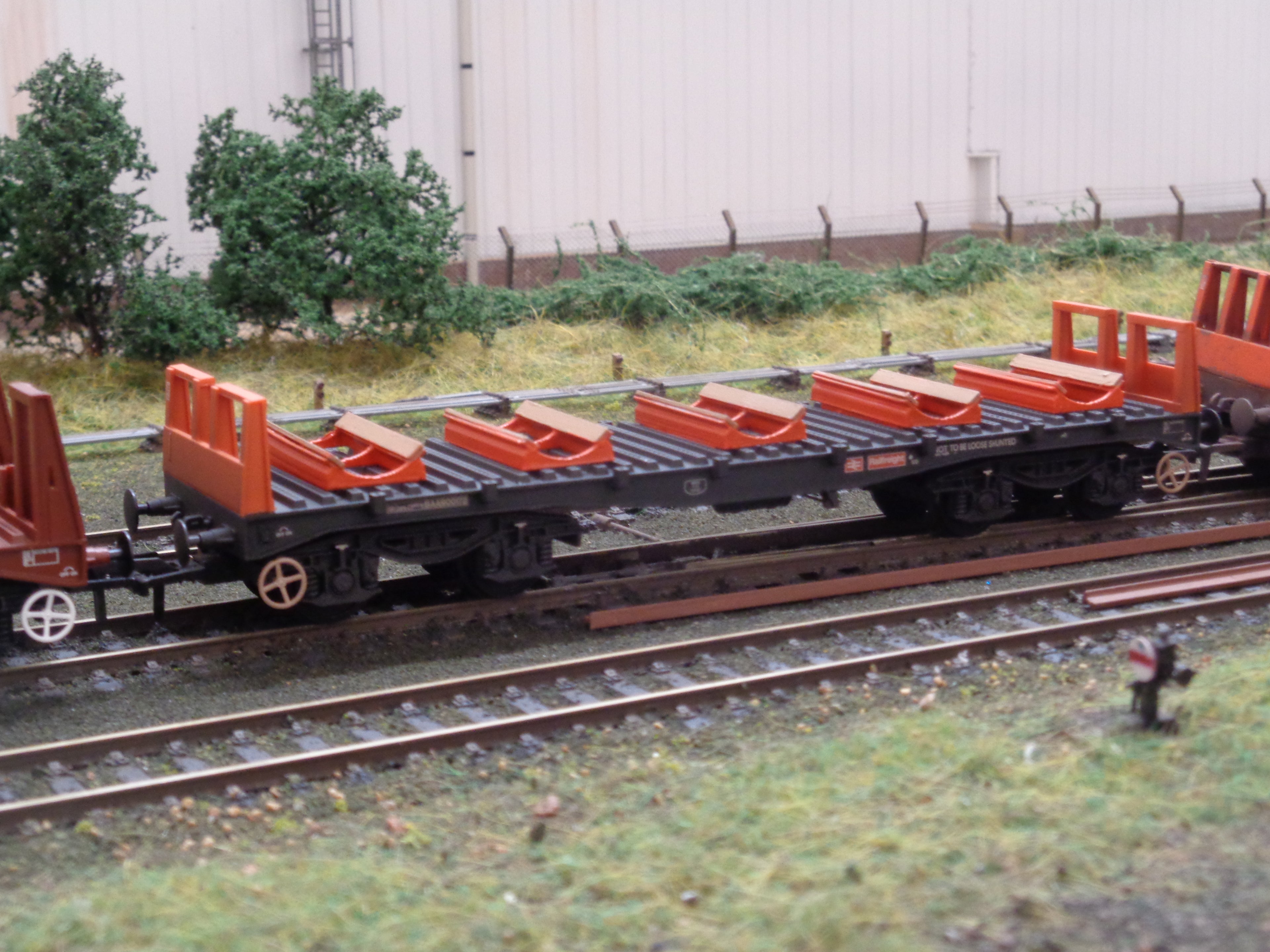 Painted OO gauge steel cradles on a wagon - Three Peaks Models