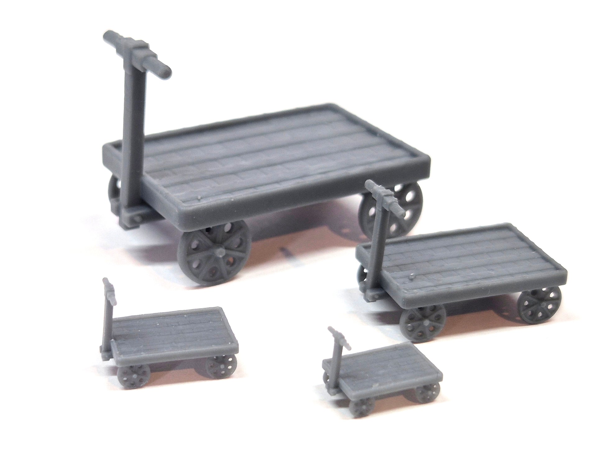 Set of 4 scale model unpainted platform trolleys in different scales - Three Peaks Models